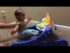 funny baby enjoying fisher-price singing stars gym as a part of baby sitting excercise